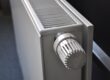 White radiator with a numbered temperature control knob, viewed at an angle from above.