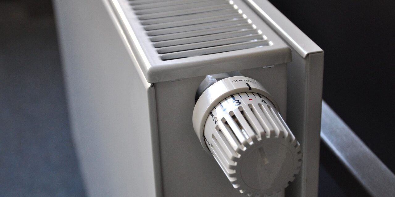 White radiator with a numbered temperature control knob, viewed at an angle from above.