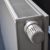 White radiator with a numbered temperature control knob, viewed at an angle from above.