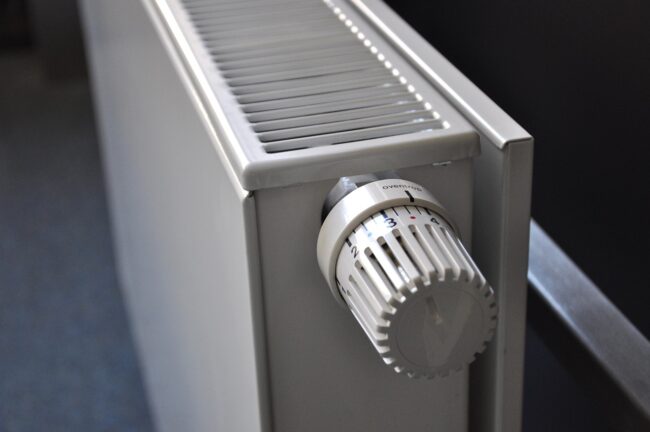 White radiator with a numbered temperature control knob, viewed at an angle from above.